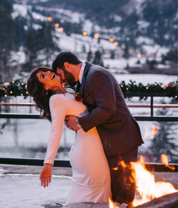 Joyful Lake Tahoe Wedding Planners couple on balcony in snow by firepit, winter wedding at venue The Resort at Squaw Creek, Lake Tahoe, Joy of Life Events home page image by Charleston Churchill